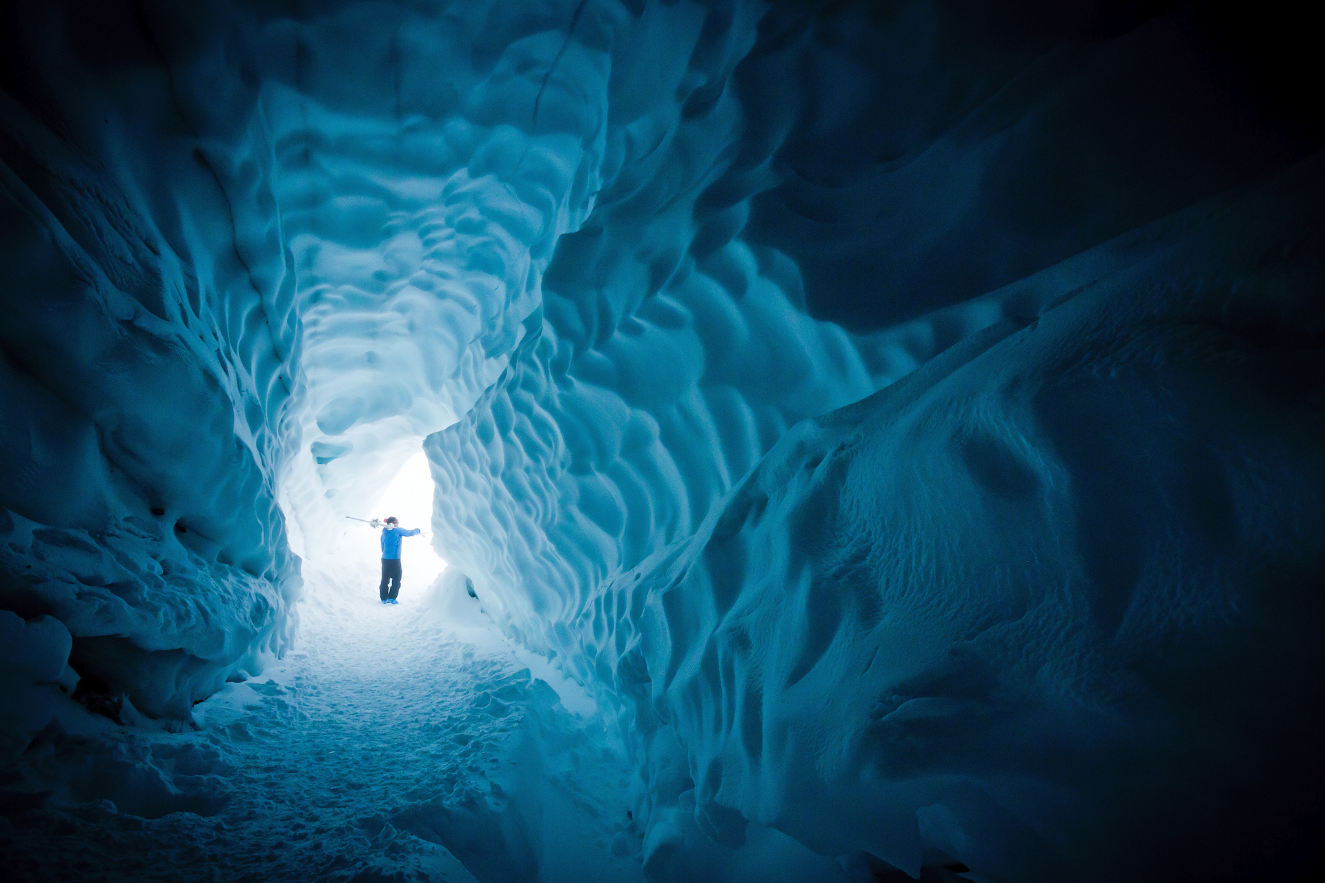 Skier exploring ice cave